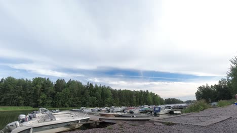 Time-lapse-of-clouds-over-boat-filled-lake