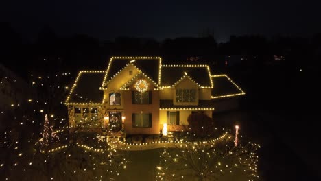 Home-with-warm-yellow-Christmas-lights-at-night,-festive-atmosphere