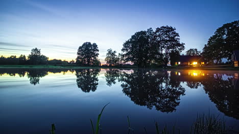 Idyllic-View-Of-A-House-Lake-With-Mirror-Reflections-During-Sunset