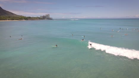 Aerial-view-of-a-man-sup-stand-up-paddleboard-surfing-in-Hawaii