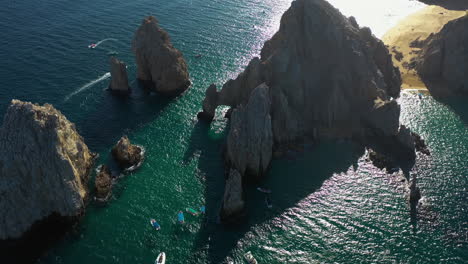 Aerial-view-tilting-away-from-the-arch-of-Cabo-San-Lucas,-sunny-day-in-Mexico