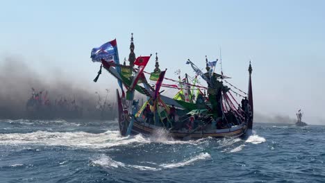 Closeup-of-fishing-boats-in-Indian-Ocean-during-Patik-Laut-festival-in-Muncar,-Banyuwangi,-Jawa,-Indonesia-covered-in-smoke-exhaust