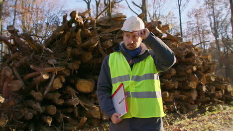 Safety-conscious-tree-specialist,-background-of-felled-tree-trunks