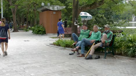 Grab-Service-drivers-of-Hanoi-sitting-down-to-chat-on-break-at-local-park