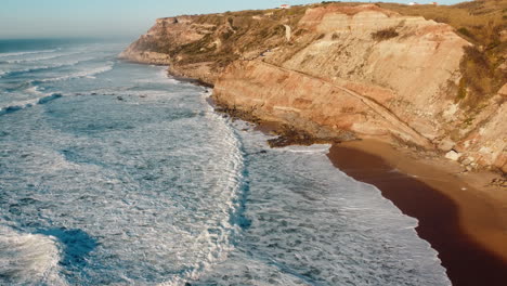 Aerial-of-relentless-sea-waves-crashing-at-rugged-coastal-area-of-Portugal