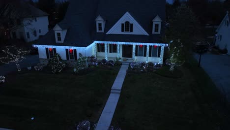 House-decorated-with-blue-Christmas-lights-at-twilight,-in-a-residential-area