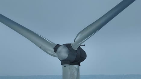 Aerial-view-wind-farm-in-winter-close-up,-the-blades-rotate-and-generate-electricity-for-consumers