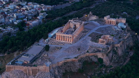 Tight-circling-aerial-shot-of-the-Acropolis-lit-up
