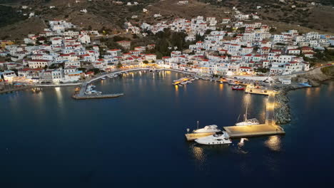 Dusk-aerial-view-of-Batsi,-a-traditional-village-at-the-island-of-Andros,-Cyclades,-Greece