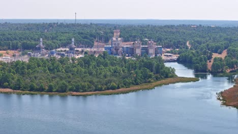 Moving-quickly-to-the-right-above-a-lake-that-has-a-power-plant-behind-it