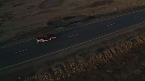 aerial-drone-view-The-drone-camera-is-moving-to-the-side-where-the-car-is-moving-up-the-road