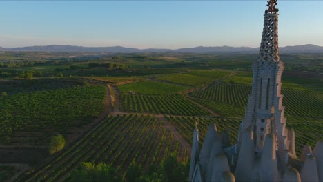 Drone-approach-to-Virgin-of-Montserrat-Sanctuary-and-vineyards,-Montferri