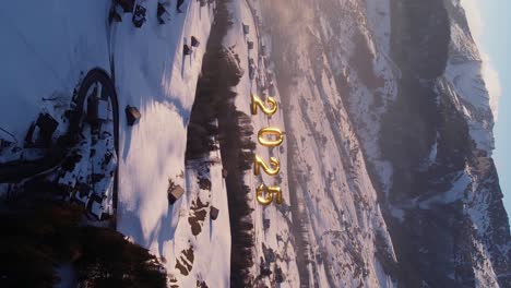 Golden-hour-aerial-view-over-snowy-Swiss-Alps-and-2025-new-year-numbers