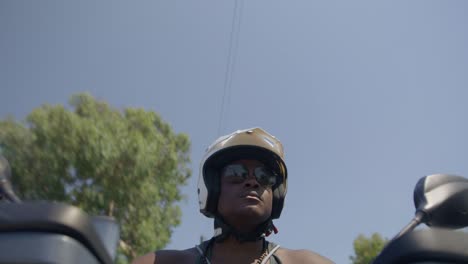 Black-Male-on-Driving-Motorbike-on-Street,-Beach-Police,-Law-Enforcement,-POV,-4K-|-Looking-Around,-Shaky,-Road,-Travel,-Large-Trees,-Searching