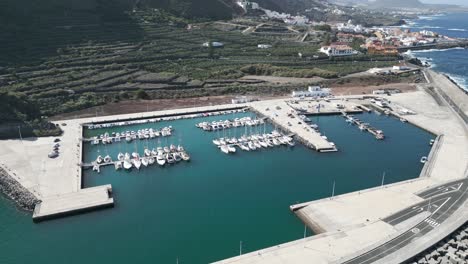 Aerial-high-angle-establishing-view-of-concrete-marina-with-boats-docked-at-port