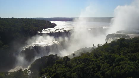 Captivating-lateral-drone-view-showcasing-the-wondrous-Iguazu-Falls,-one-of-the-Seven-Wonders-of-the-World