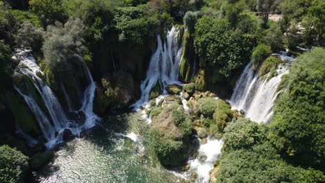 Remote-nature-paradise-with-scenic-waterfall-cascades-in-Summer,-aerial-static