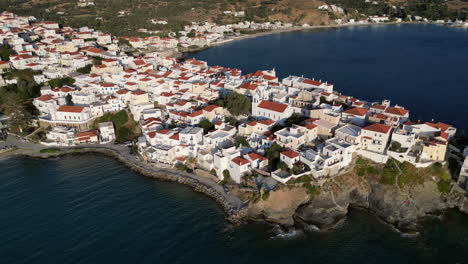Aerial-drone-bird's-eye-view-video-of-iconic-and-picturesque-Andros-island-chora,-Cyclades,-Greece