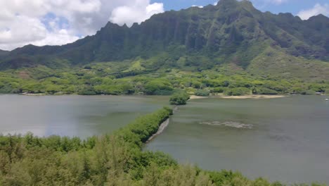 Aerial-shot-of-Kane'ohe-Bay-and-the-Moli'i-Fish-Pond-and-mountains-against-the-sky