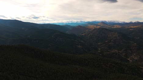 Panoramic-aerial-pullback-over-rolling-mountain-valleys-in-shadow-of-clouds-at-Lost-Gulch-Overlook-Boulder-Colorado