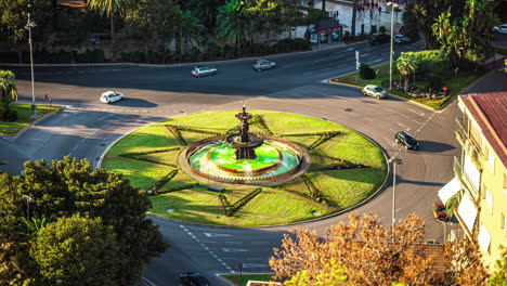 Roundabout-with-grass-and-flowers-in-Malaga,-a-fountain-in-the-middle