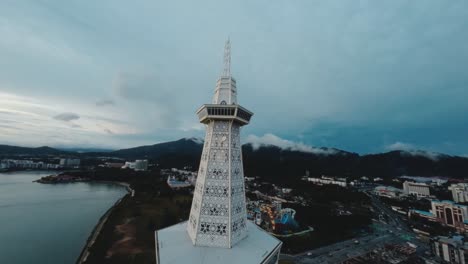 FPV-footage-provides-an-exceptional-view-of-the-MAHA-Tower-in-Langkawi,-showcasing-its-modern-architectural-elegance-and-the-surrounding-tropical-landscape-from-a-breathtaking-aerial-perspective