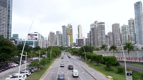 Avenida-Balboa-road-in-Panama-City,-Panama,-lined-with-palm-trees-and-a-skyline-of-tall-buildings