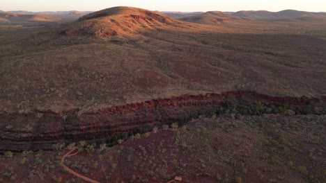 Aerial-Panorama-view-of-Karijini-Area-with-hills-and-ravine-at-sunset-time