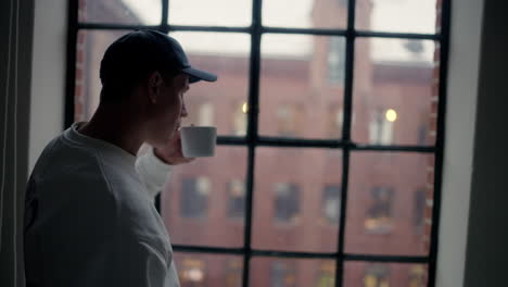 Contemplative-moment-with-a-hot-cup-by-the-window