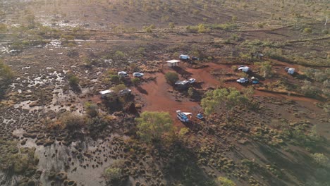 Aerial-top-down-shot-of-cars-and-tents-at-dales-campground-in-Karijini-national-Park---tilt-up-shot
