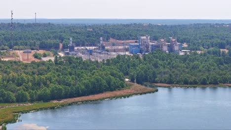 Moving-up-and-quickly-to-the-right-above-a-large-lake-inlet-that-has-a-power-plant-behind-it