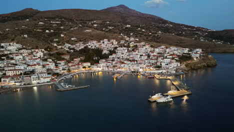 Dusk-aerial-view-of-Batsi,-a-traditional-village-at-the-island-of-Andros,-Cyclades,-Greece