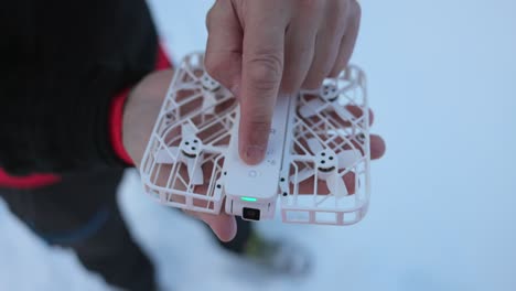 Overhead-View-Of-Hoverair-X1-Pocket-Sized-Flying-Drone-On-Palm-Of-Hand