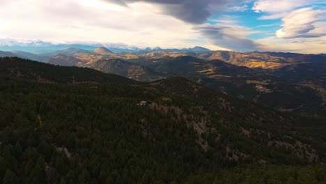Drone-rises-above-pine-tree-forest-to-reveal-incredible-fall-colored-valleys-from-Lost-Gulch-Overlook-Boulder-Colorado