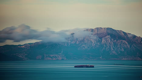 Boote-Und-Wolken-Fahren-über-Ein-Blaues-Meer-Mit-Bergen-Im-Hintergrund
