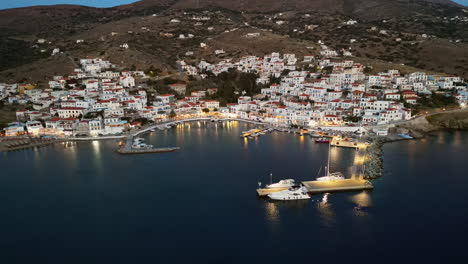 Aerial-drone-view-of-picturesque-village-of-Batsi-with-traditional-taverns-and-clear-water-beach,-Andros-island,-Cyclades,-Greece