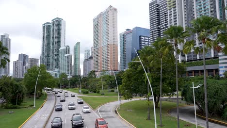 Avenida-Balboa-road-in-Panama-City,-Panama,-lined-with-palm-trees-and-a-skyline-of-tall-buildings