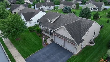 Aerial-view-of-a-suburban-home-with-a-landscaped-yard-and-driveway