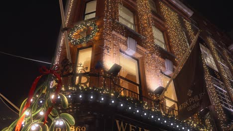 Night-view-of-the-Weir-and-Sons-shop-decorated-for-Christmas-in-Dublin,-Ireland