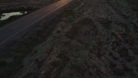 aerial-drone-view-drone-camera-moving-forward,-road-shining-with-sunlight
