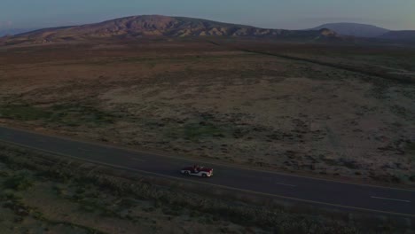 aerial-drone-view-cinematic-shot-in-beautiful-couple-going-in-a-car