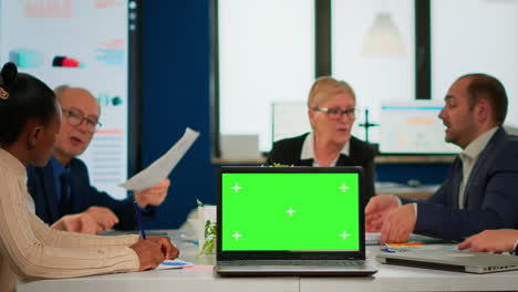 Group-of-business-people-discussing-company-plan-with-mockup-laptop