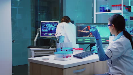 Group-of-scientists-wearing-lab-coat-working-in-laboratory
