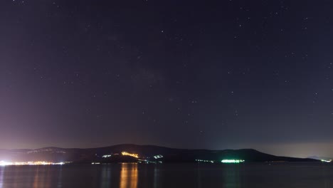 Beautiful-sea-time-lapse-during-night-with-stars-and-city-lights.-Turkey,-Didim