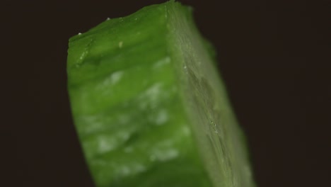 Rotate-of-cucumber-piece-on-a-dark-background