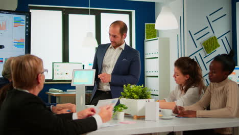 Startup-diversity-teamwork-brainstorming-sitting-at-desk-in-modern-office