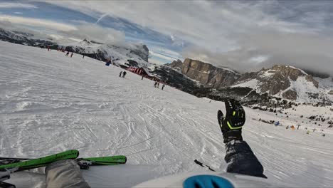 People-skiing-and-snowboarding-down-the-ski-slope-or-piste-in-the-mountains