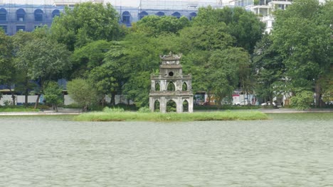 Lake-water-flowing-past-small-architectural-design