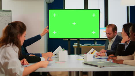 Group-of-business-people-discussing-company-plan-with-mockup-tv-green-screen