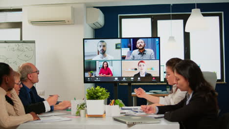 Headshot-screen-application-view-of-remote-multiracial-employees-talking-on-video-call
